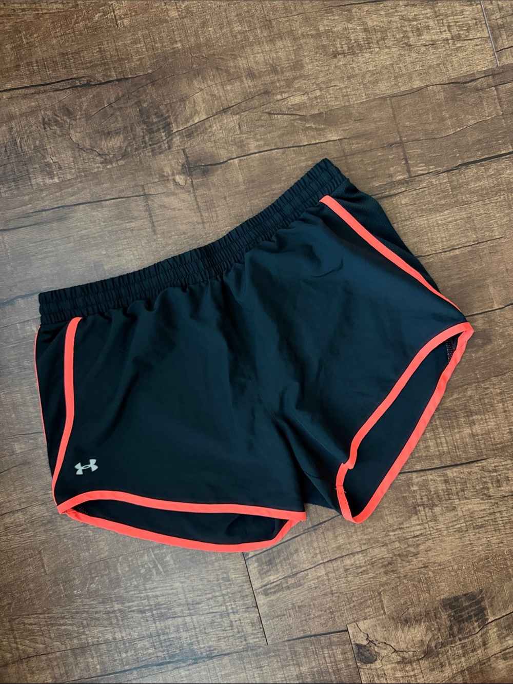 Under Armour black athletic shorts with orange trim